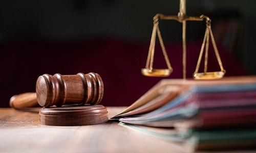 Gavel and legal paperwork on a desk